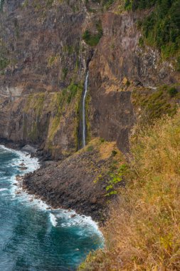 Natural cascade of water into the sea at the Miradouro do Veu da Noiva viewpoint in Madeira. Portugal