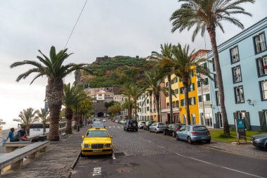 Ponta do sol beach in the east of Madeira in summer, palm trees and colored houses