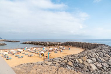 Praia da Calheta in summer, beach in summer with tourists, Madeira. Portugal