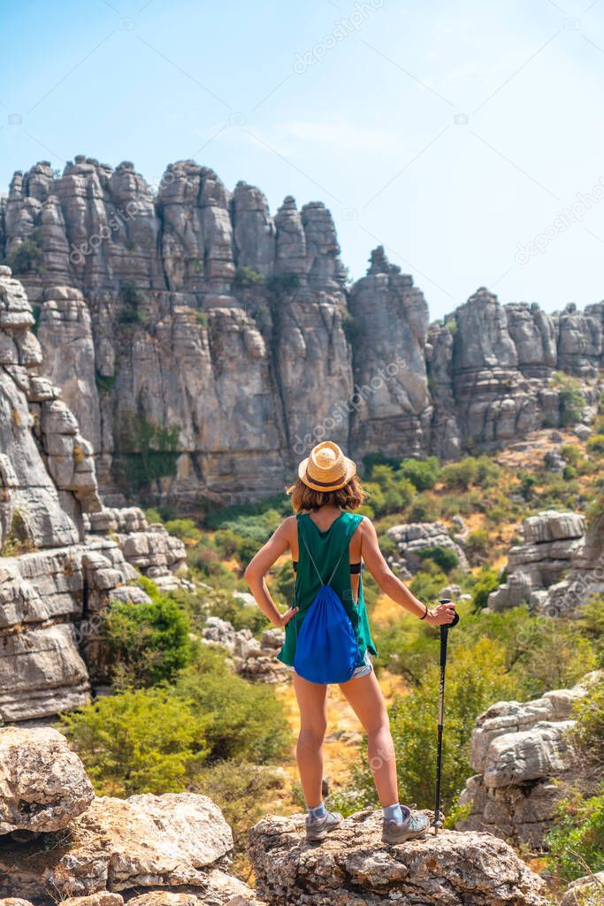 A young woman in Torcal de Antequera on the green and yellow trail enjoying freedom, Malaga. Andalusia