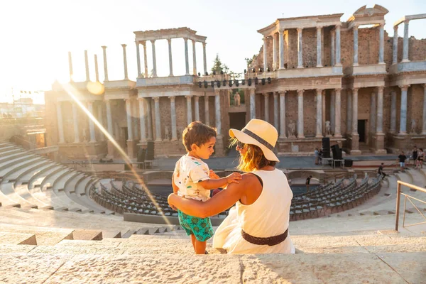 Roman Ruins of Merida, a mother with her baby visiting the Roman Theater. Extremadura, Spain