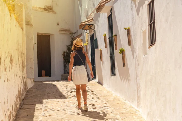 A tourist woman walking through the white houses of Vejer de la Frontera, Cadiz. Andalusia