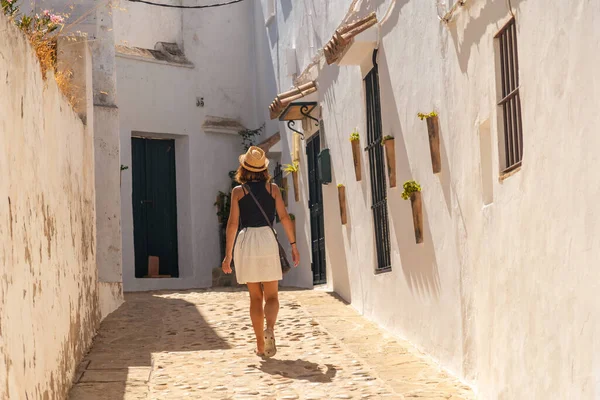 A tourist woman walking through the white houses of Vejer de la Frontera, Cadiz. Andalusia