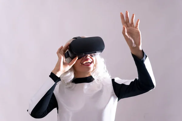 Close-up of adult woman gesturing with virtual reality goggles, metaverse