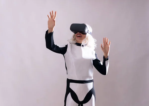 Close-up of woman with virtual reality glasses hallucinating with the future, metaverse on a white background