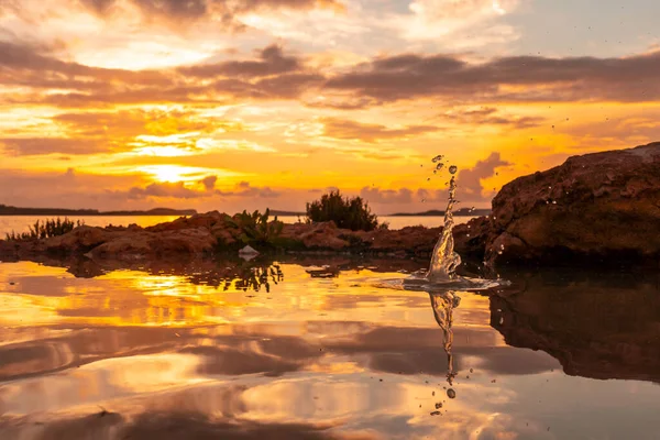 Drops of water after the throwing of a stone at sunset in San Antonio Abad, Ibiza Island