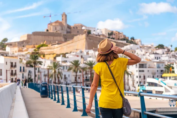 A young woman on spring vacation in Ibiza town next to the lighthouse, Balearic Islands