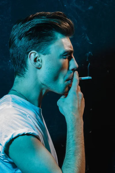 Beau jeune homme fumant de la cigarette — Photo