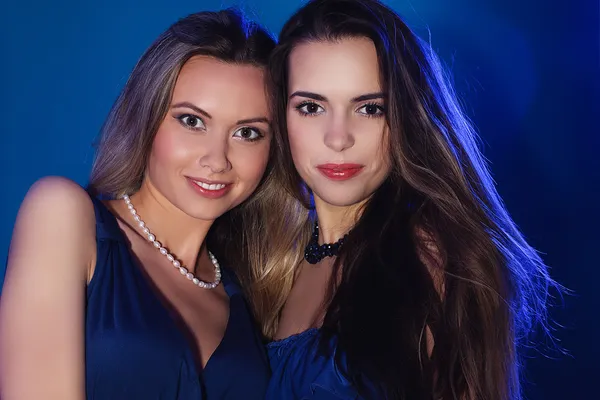 Two fashion girls on  blue background — Stock Photo, Image