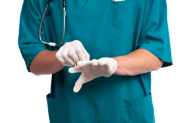 Doctor putting on protective gloves — Stock Photo, Image