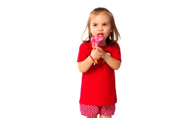Cute little girl with a lollipop — Stock Photo, Image