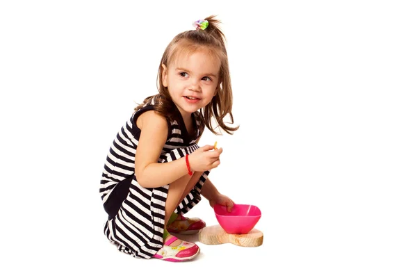 Small girl eat corn flakes isolated on white — Stock Photo, Image