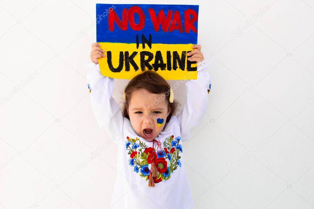 A portrait of a girl in an embroidered shirt calls to stop the war in Ukraine, raises a banner with the inscription 