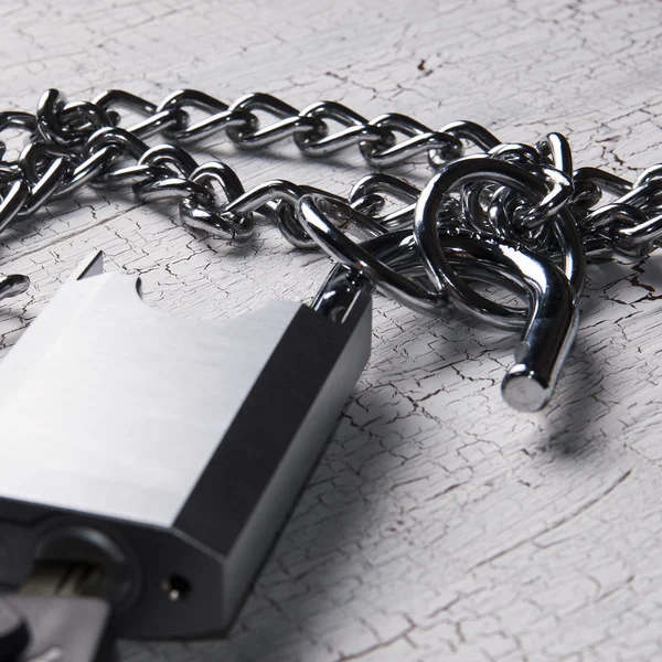 Padlock and chain on wooden table — Stock Photo, Image