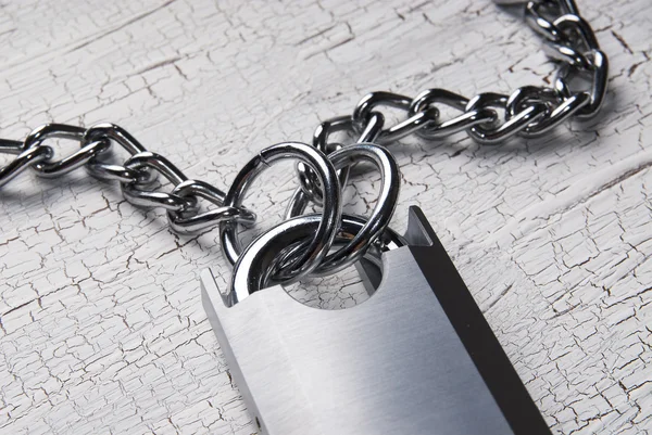 Padlock and chain on wooden table — Stock Photo, Image