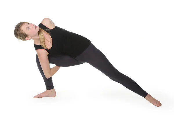 Beautiful young woman in great shape practicing yoga — Stock Photo, Image