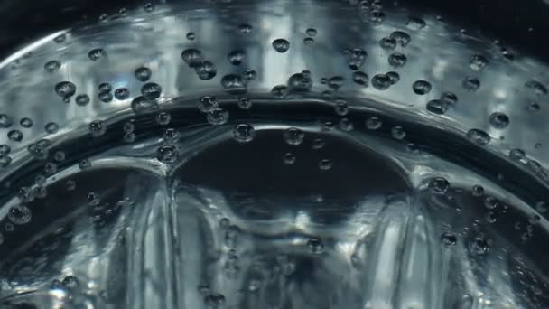 Стакан воды с поднимающимися пузырями — стоковое видео