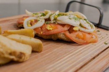 Delicious Italian food. Napolitan Milanese with fries on the table.