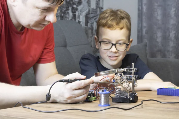 Man Solders Child Learns Solder Parts Father Son Solder Together — стоковое фото