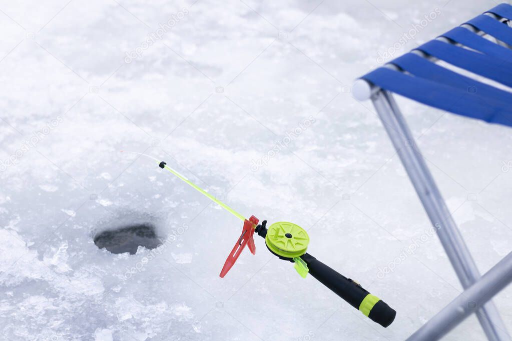 Small winter fishing rod with ice, winter fishing