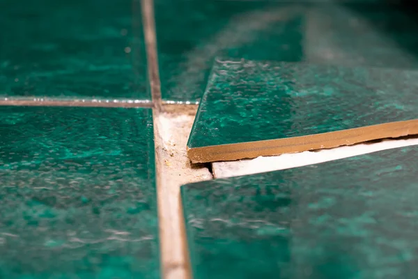 Seramik seramik döşeme, uygun olmayan yapı malzemelerinden dolayı çatlaklar. Kiremit Parçası