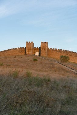 View of Arraiolos castle on top of the hill in Alentejo, Portugal at sunset