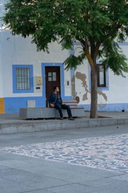 Men sit on a bench in Arraiolos Alentejo, Portugal