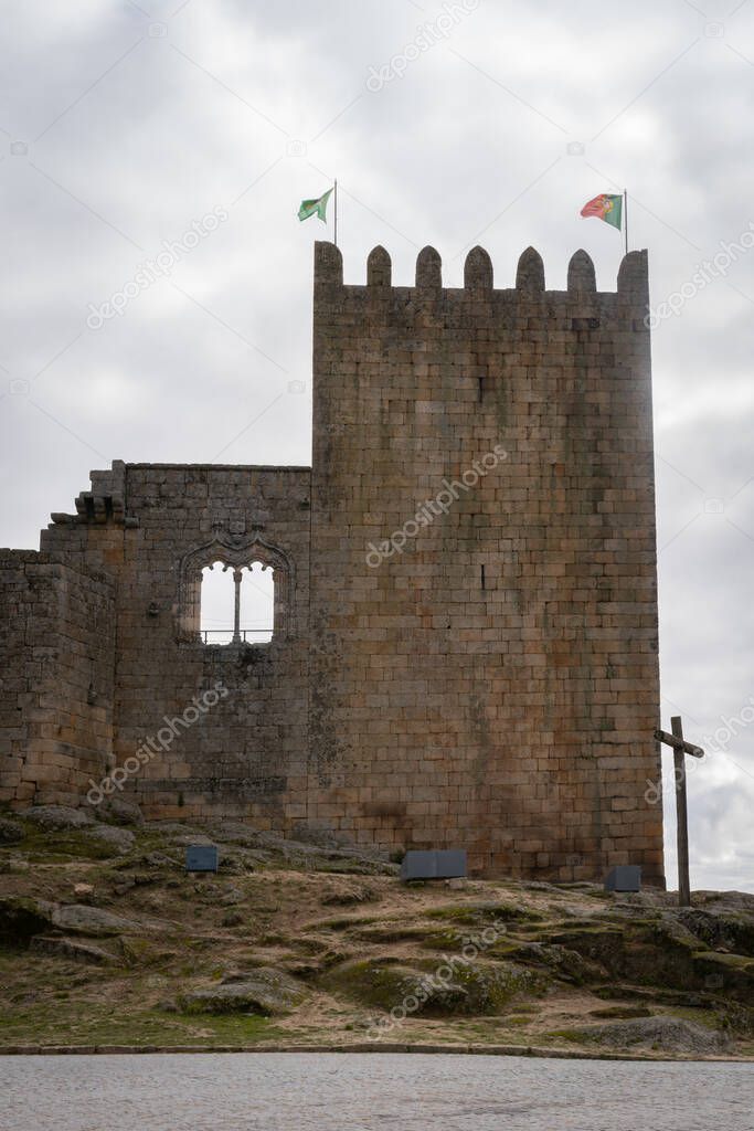 Tower castle of historic village Belmonte with cross and Brazil and Portugal flag, in Portugal