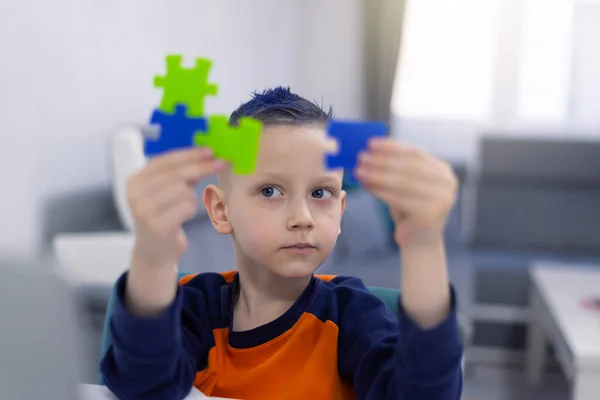Mały Uczeń Trzyma Kawałki Układanki Próbuje Rozwiązać — Zdjęcie stockowe