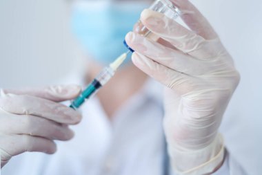 Female doctor preparing syringe. Beautiful nurse preparing a syringe