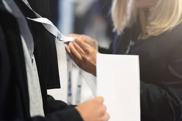 Conference Staff Member scan a QR code from attendee upon arrival to check-in site