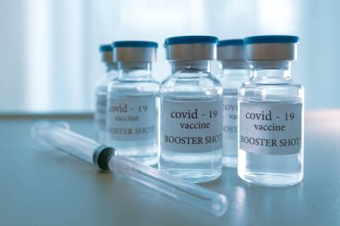 COVID-19 booster vaccine vial. Medicine and health care concept