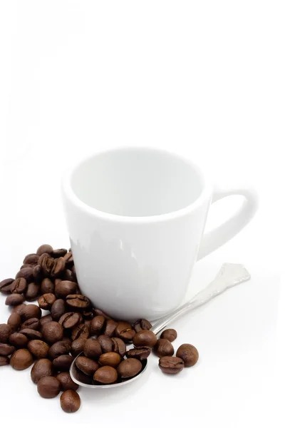 Coffe beans with a cup and spoon Royalty Free Stock Images