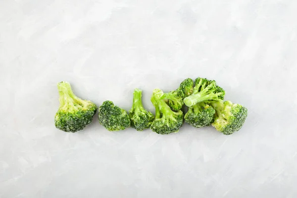 Frozen Green broccoli. Frozen vegetables lie on the table. Food Reserve. Healthy fast ingredients for cooking.