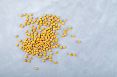 Leblebi ya da gri arka planda kızarmış nohut. Kızarmış Türk bezelyesi sarısı rengi. Lezzetli sağlıklı atıştırmalık. Üst görünüm, alanı kopyala.