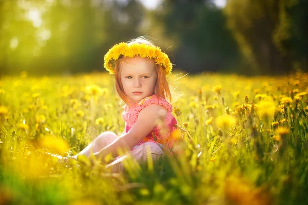 Image of happy child on dandelions field, cheerful little girl r — Stock Photo, Image