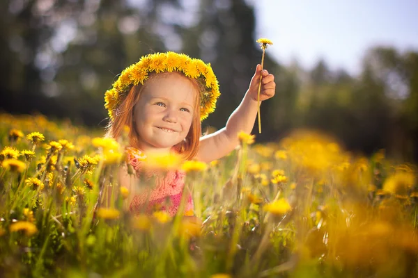 Image of happy child on dandelions field, cheerful little girl r — Stock Photo, Image