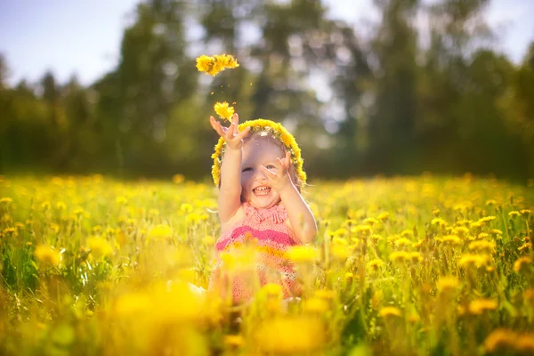 Image of happy child on dandelions field, cheerful little girl r — Stock Photo, Image