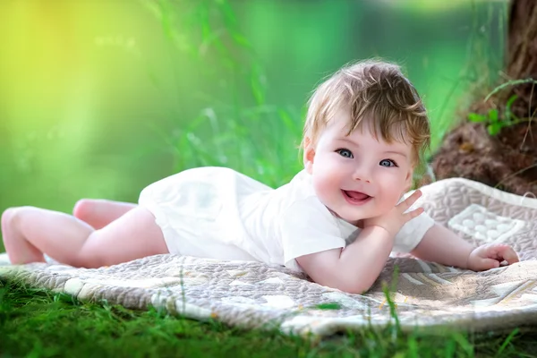 Happy little baby having fun in the park on the lake shore backg — Stock Photo, Image