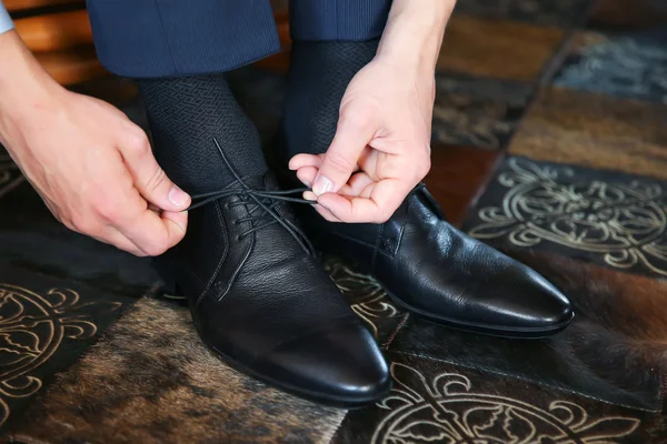 Biznesmen wprowadzenie na czarne skórzane buty do pracy. — Zdjęcie stockowe
