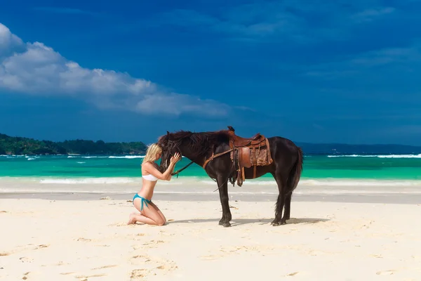 Happy girl walking with horse on a tropical beach — Stock Photo, Image