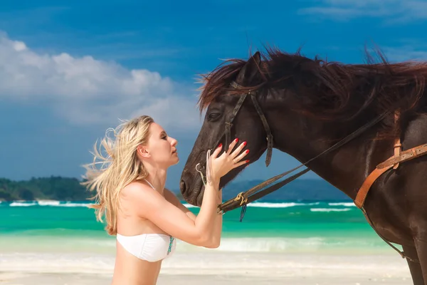 Happy girl walking with horse on a tropical beach — Stock Photo, Image