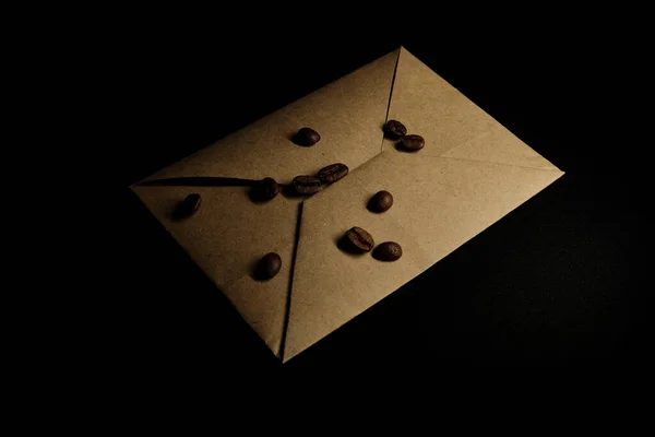 Coffee Beans Kraft Paper Envelope Black Background — Stock Photo, Image
