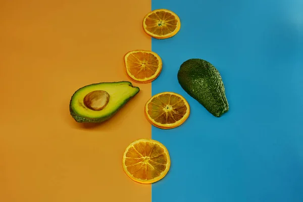 Gedroogde Oranje Ringen Gesneden Avocado Een Pastelachtergrond Met — Stockfoto