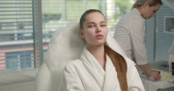 Hasil perawatan kecantikan. Wanita cantik yang sehat duduk menunggu ahli kosmetologi — Stok Video