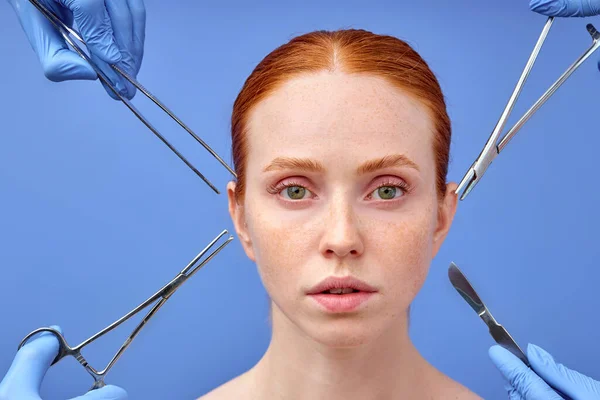 Nyugodt nő vörös haj néz kamera gondolkodás műtét folyamata. — Stock Fotó