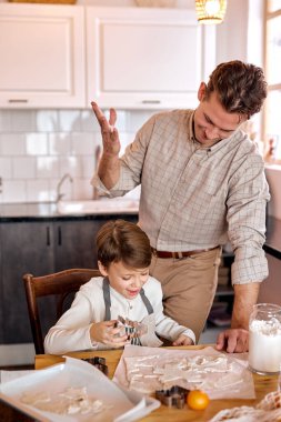 Bakıcı baba, oğlunla konuşmana yardım ediyor. Kurabiye hazırlıyor, tatillerde kurabiye yapıyor.