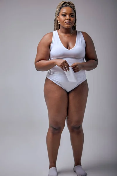 pretty plus size or plump woman with chubby natural body holding napkin, posing