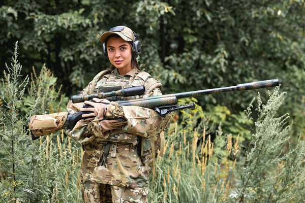 Ormanda elinde silah tutan genç bir kadının portresi. — Stok fotoğraf