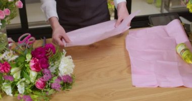 Çiçekçi iş başında. Kadınlar farklı çiçeklerden modern buket yapıyorlar.